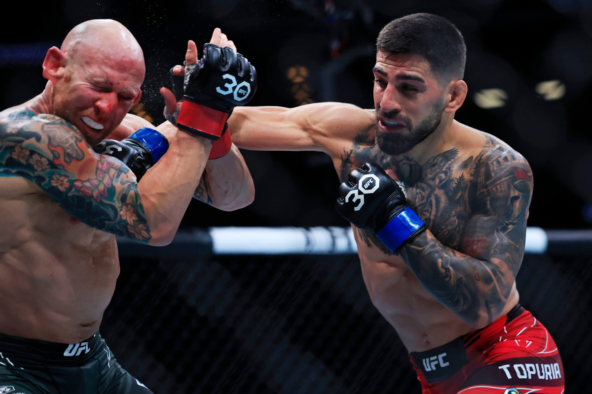 Ilia Topuria lands a punch on Josh Emmett in the main event of UFC Jacksonville.